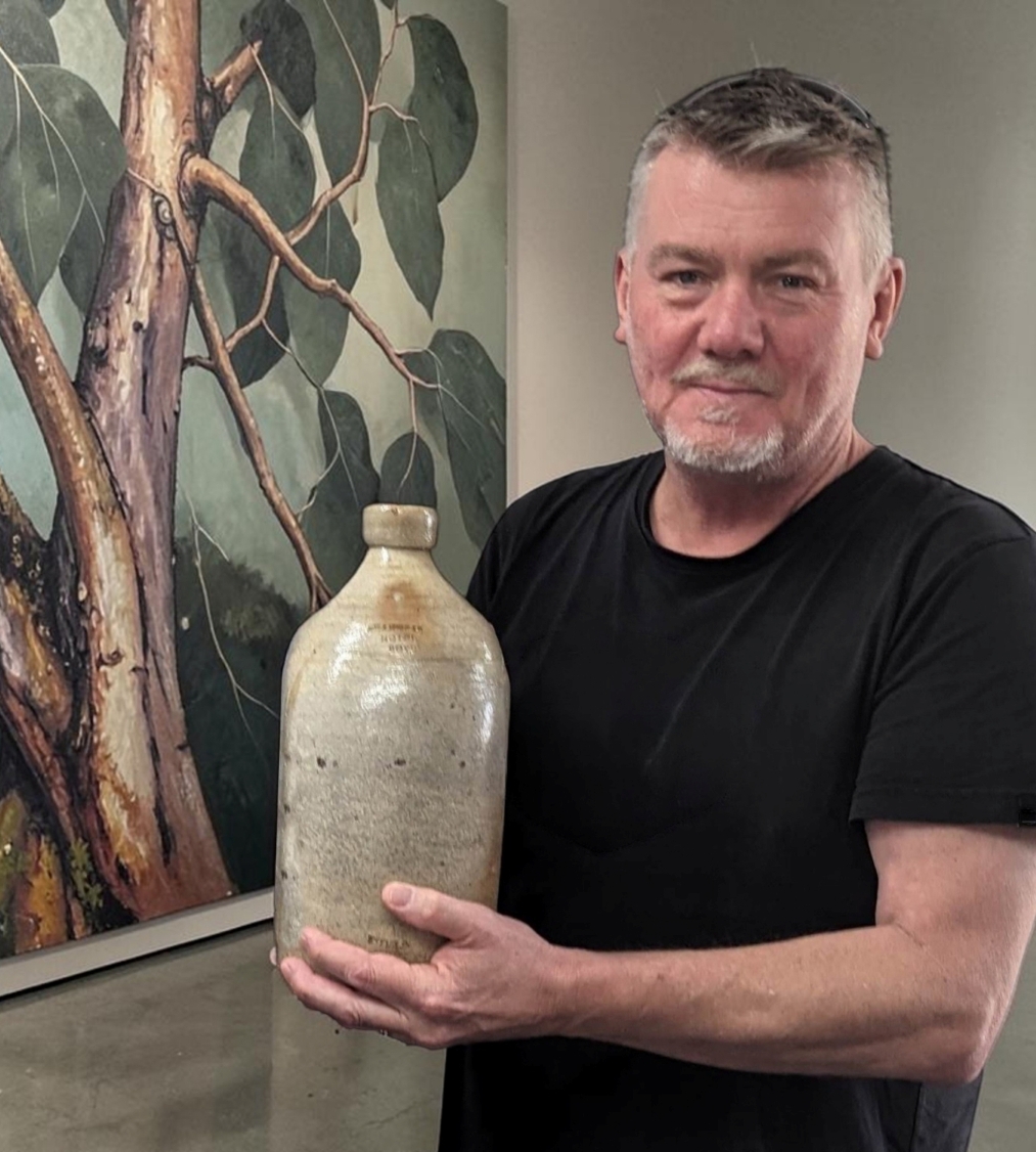 Graham Lancaster holding Seahorse Hotel Demijohn from Boydtown world record $55,000 incl. BP